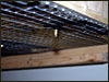This shows the sipper poking through the wire mesh..........it is attached to a clip which keeps it in place.........this is why the T bar rails are cut back 3"s...........the tub has to be able to drop down out of the T bar before it hits the sipper.